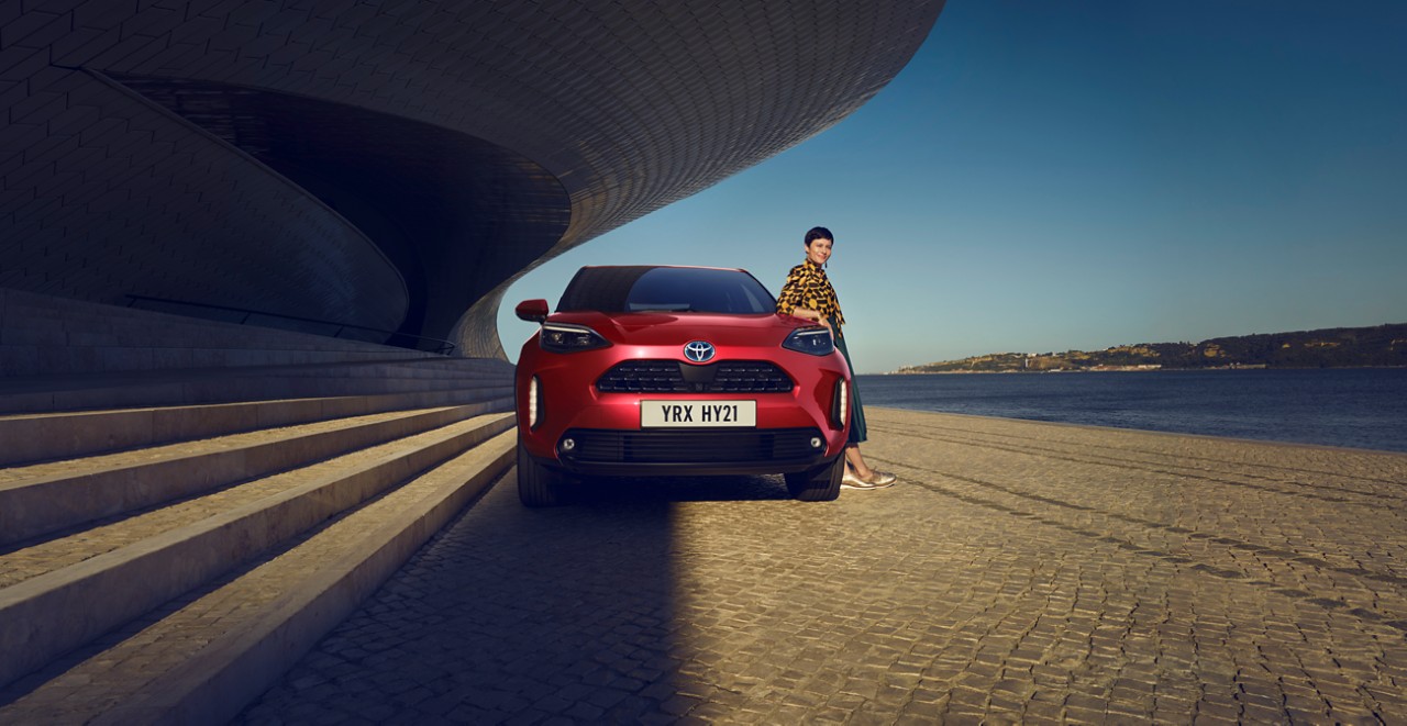 Woman next to Toyota Yaris Cross