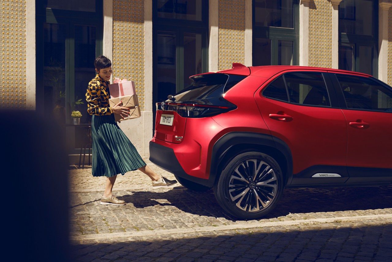 Woman opening boot of Toyota Yaris Cross